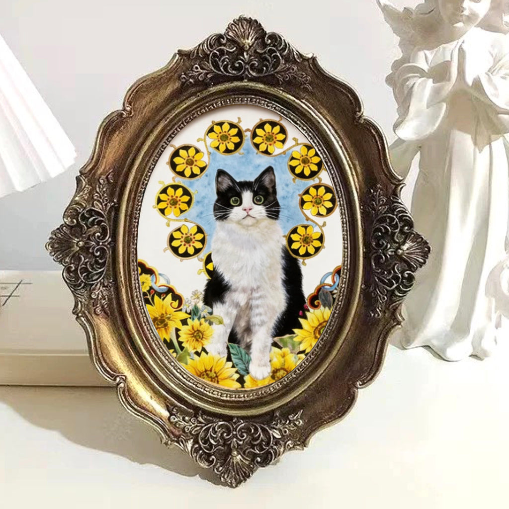 Decorative framed picture of a black and white cat among yellow flowers on a white surface.